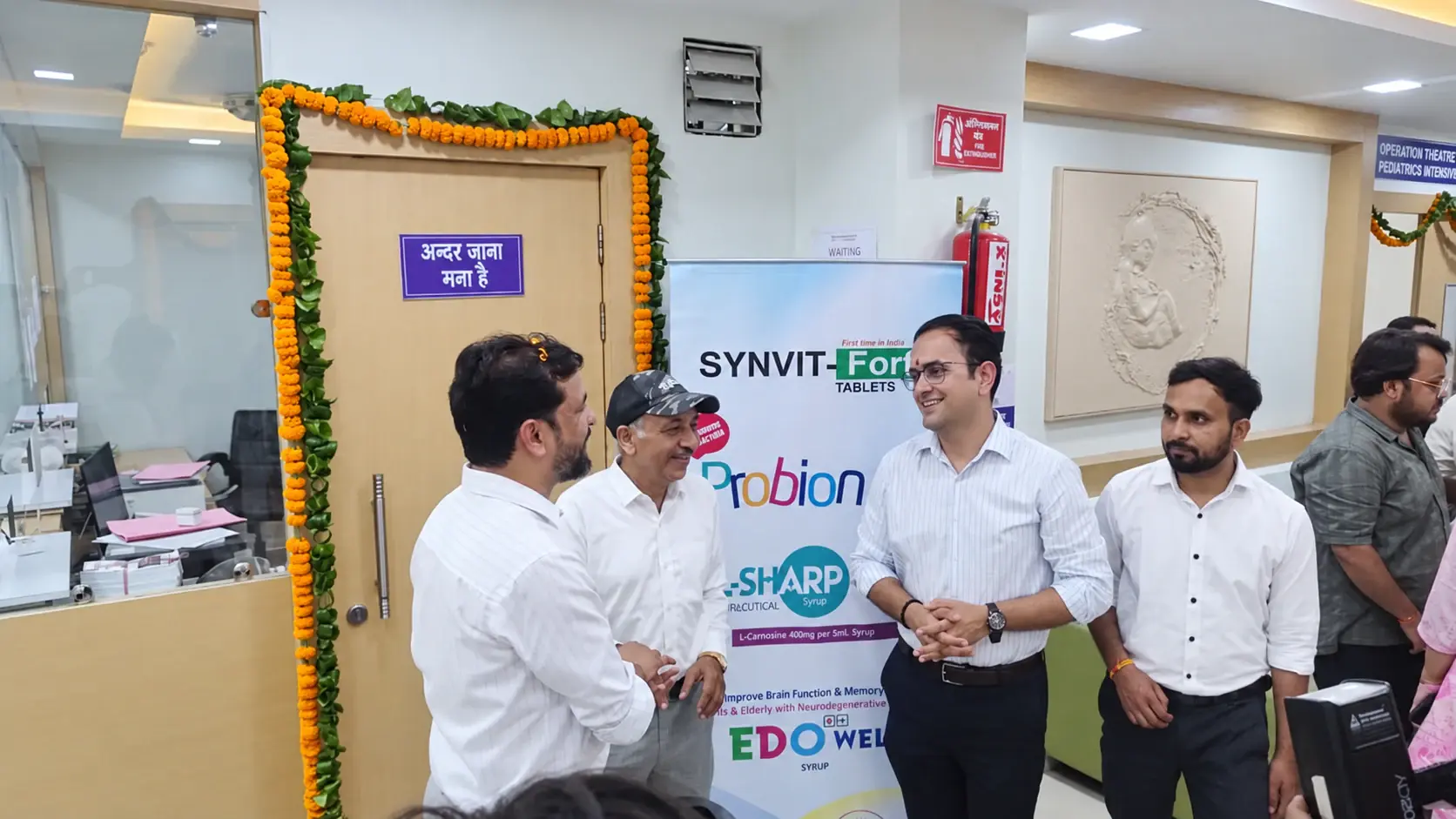 Healthcare professionals in conversation beside a Leaf Genix product display